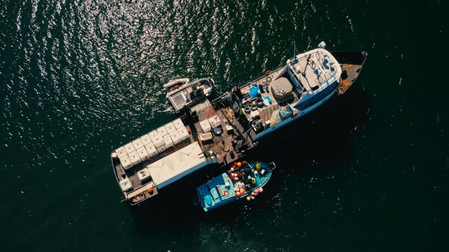 An aerial view of two boats alongside each other.