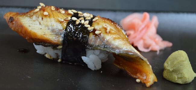 A close up photo of a plant-based fish fillet dressed in a plate.