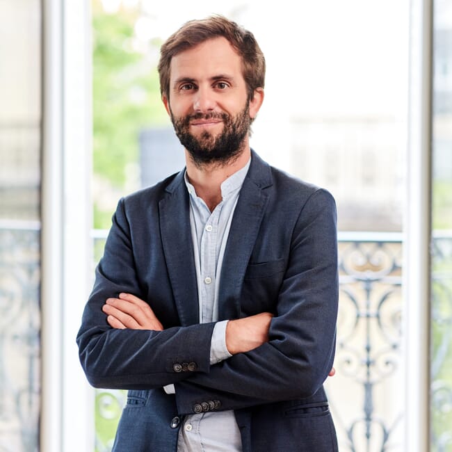A man in a suit posting for a professional photo