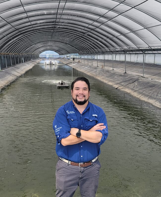 Man in from of covered pond
