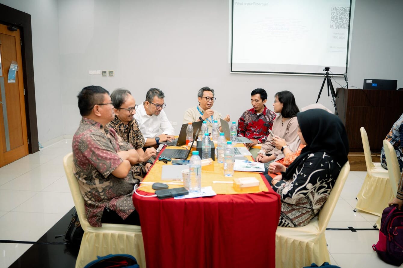 A group of stakeholders around a table having discussions in Indonesia.