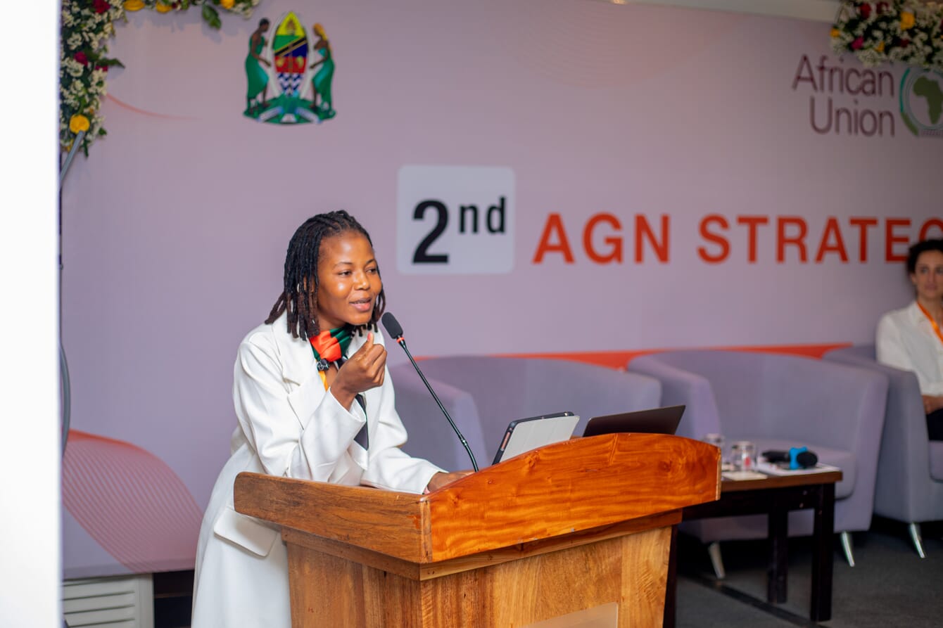 A woman delivering a presentation at an event.