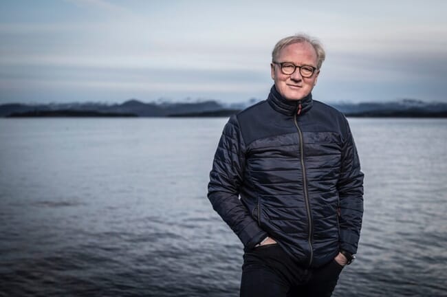 A man standing by the sea shore.