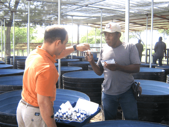 Two people discussing scientific work on a farm.
